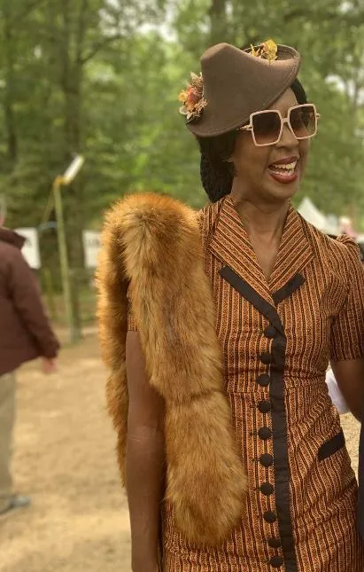 Dionne Curd, founder of Living Intentionally, dressed in vintage 1940s style and laughing