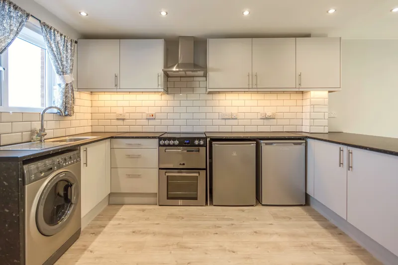 The kitchen — fully fitted with warm under-cabinet lighting and everything in its place